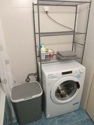 a laundry room with a washing machine and a basket at Arena Usce Confluence in Belgrade