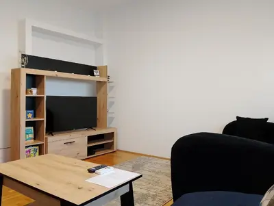a living room with a tv and a coffee table at Arena Usce Confluence in Belgrade