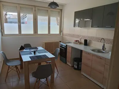 a kitchen with a table and chairs and a sink at Arena Usce Confluence in Belgrade