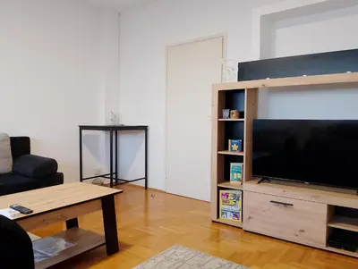 a living room with a large flat screen tv at Arena Usce Confluence in Belgrade