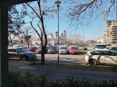 a parking lot with a lot of cars parked at Arena Usce Confluence in Belgrade