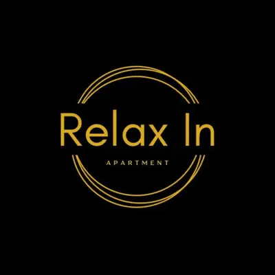 a gold circle logo on a black background at Relax In in Belgrade