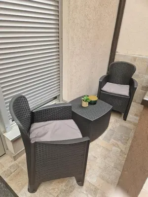 two chairs and a table on a balcony at Relax In in Belgrade
