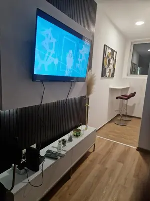 a living room with a flat screen tv on a wall at Relax In in Belgrade