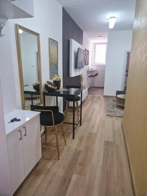 a living room with a table and chairs at Relax In in Belgrade