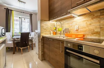 a kitchen with a counter and a dining room at Chic apartment Dorćol in Belgrade