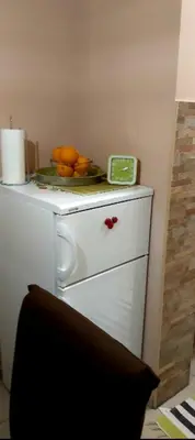 a plate of oranges on top of a refrigerator at Chic apartment Dorćol in Belgrade
