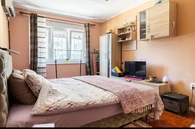 a bedroom with a bed and a desk with a computer at Chic apartment Dorćol in Belgrade
