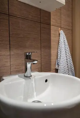 a bathroom sink with a faucet on top of it at Chic apartment Dorćol in Belgrade