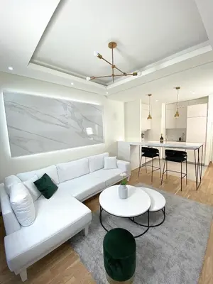 a living room with a white couch and a table at Belgrade Waterfront Lux Vista -free parking in Belgrade