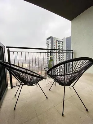 a chair on a balcony with a view of a city at Belgrade Waterfront Lux Vista -free parking in Belgrade