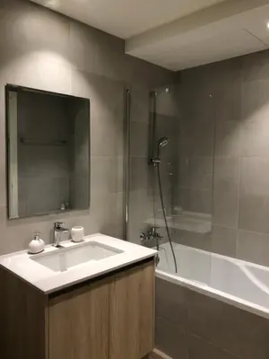 a bathroom with a sink and a shower and a tub at Belgrade Waterfront Lux Vista -free parking in Belgrade