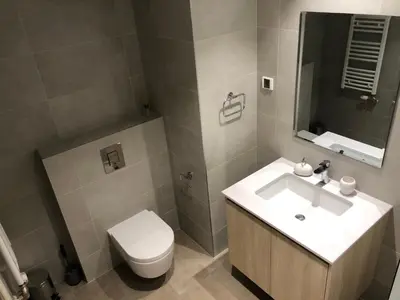 a bathroom with a white sink and a toilet at Belgrade Waterfront Lux Vista -free parking in Belgrade