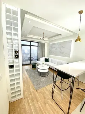 a white living room with a table and a couch at Belgrade Waterfront Lux Vista -free parking in Belgrade