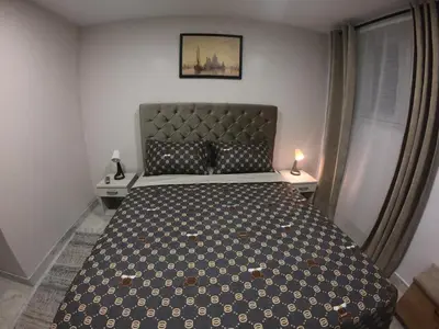 a bedroom with a large bed with two night stands at Apartman Knez in Belgrade
