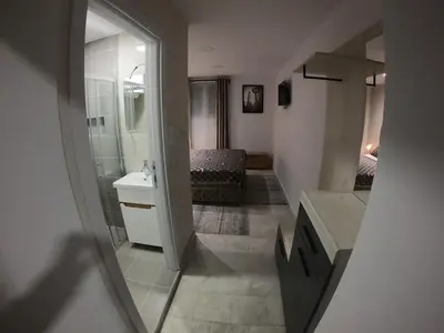 a bathroom with a shower and a sink and a mirror at Apartman Knez in Belgrade