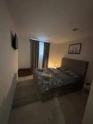 a bedroom with a bed and a window at Apartman Miloš in Belgrade