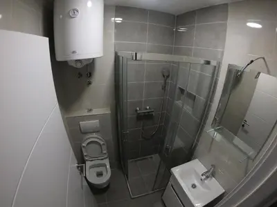 a bathroom with a shower and a toilet and a sink at Apartman Miloš in Belgrade