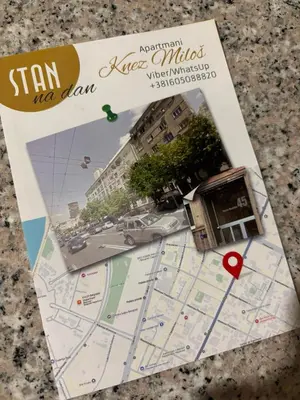 a book with a map and a red heart at Apartman Miloš in Belgrade