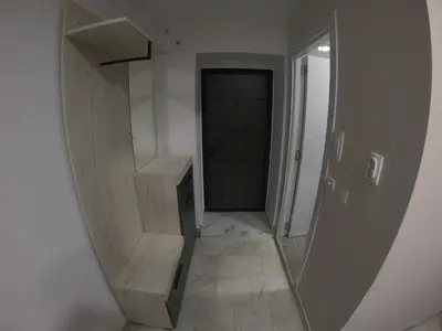 a hallway with a mirror in a room with a door at Apartman Miloš in Belgrade