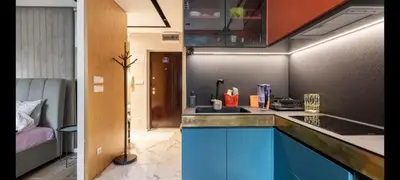a kitchen with a sink and a room with a bed at Mini Dorćolka apartment -Dorćol in Belgrade