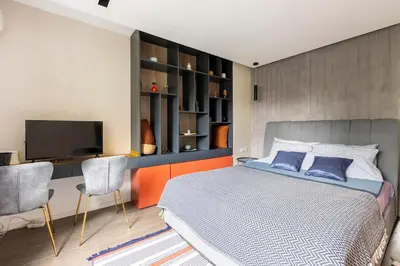 a bedroom with a bed and a flat screen tv at Mini Dorćolka apartment -Dorćol in Belgrade