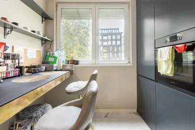 a kitchen with a chair next to a window at Mini Dorćolka apartment -Dorćol in Belgrade