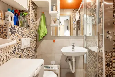 a bathroom with a sink and a toilet and a shower at Mini Dorćolka apartment -Dorćol in Belgrade