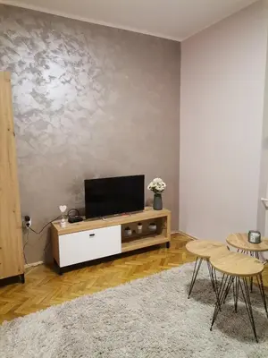 a living room with a flat screen tv on a cabinet at Apartman petrov 1 in Pančevo
