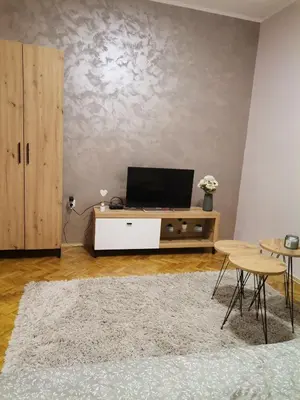 a living room with a tv on a cabinet at Apartman petrov 1 in Pančevo