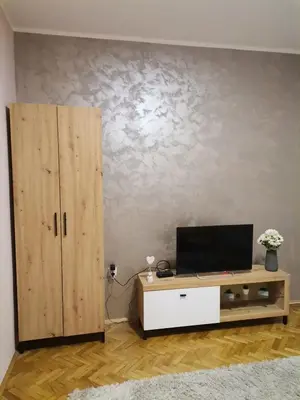 a living room with a tv and a cabinet at Apartman petrov 1 in Pančevo