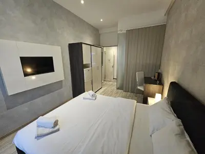 a bedroom with a bed with two towels on it at Central Park Rooms in Belgrade