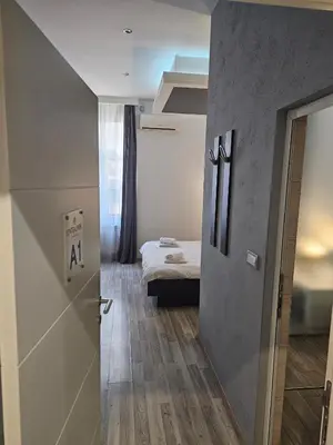a room with a room with a bed and a door at Central Park Rooms in Belgrade