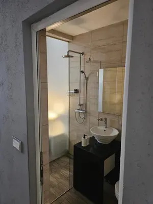 a bathroom with a sink and a shower at Central Park Rooms in Belgrade