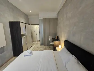a bedroom with a large bed in a room at Central Park Rooms in Belgrade