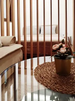 a living room with a table and a bed at Grujo Apartment in Belgrade