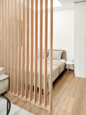 a bed with a wooden crib in a room at Grujo Apartment in Belgrade