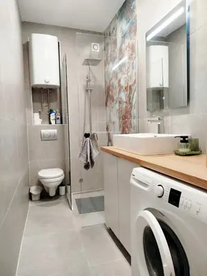 a bathroom with a sink and a washing machine at Grujo Apartment in Belgrade