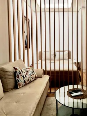 a living room with a crib with a couch and a table at Grujo Apartment in Belgrade