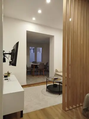 a living room with a kitchen and a dining room at Grujo Apartment in Belgrade