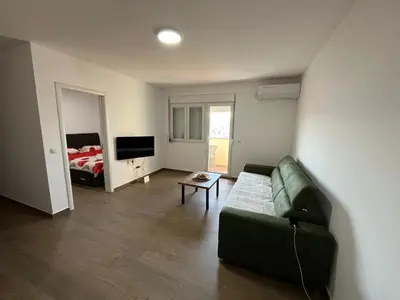 a living room with a couch and a bed at Mimura stan in Belgrade