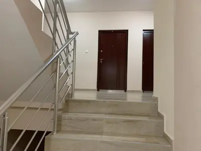 a hallway with two doors and stairs in a building at Mimura stan 2 in Belgrade