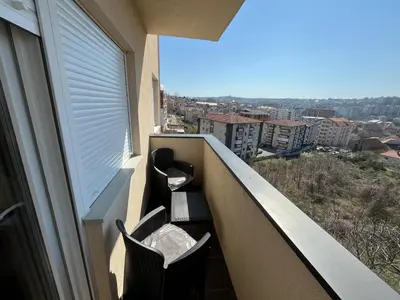 a balcony with chairs and a view of a city at Mimura stan 2 in Belgrade