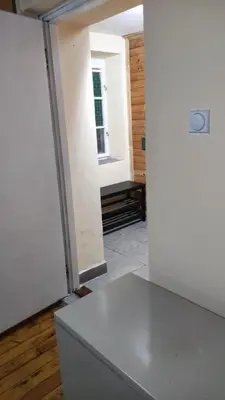 a room with a white door and a table at Goxy flat in Belgrade