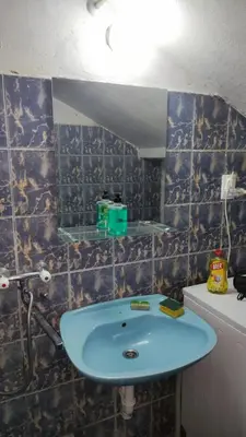 a bathroom with a blue sink and a mirror at Goxy flat in Belgrade
