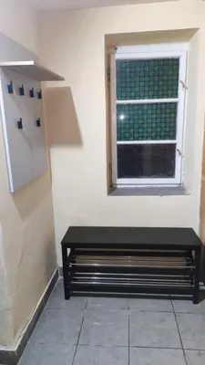 a black bench in a room with a window at Goxy flat in Belgrade
