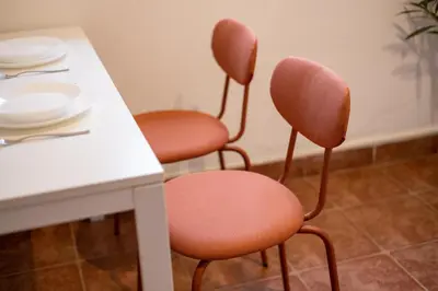 a table with two chairs and a table with plates on it at Tiny apartment in Belgrade