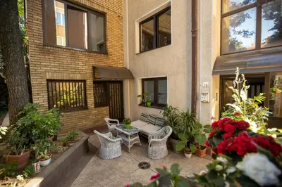 a patio with a table and chairs in front of a building at Tiny apartment in Belgrade
