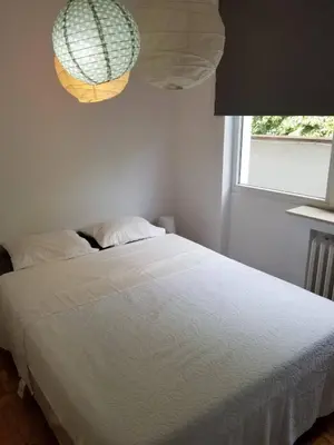 a bedroom with a white bed and a window at Belgrade Panoramic View Large Terrace Free Parking in Belgrade