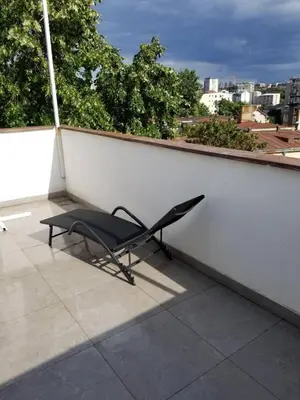 a chair sitting on top of a roof at Belgrade Panoramic View Large Terrace Free Parking in Belgrade